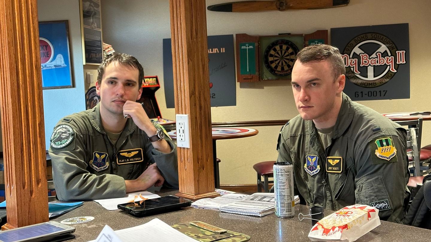 Student pilot 1st Lt. Clay Hultgren, left, and student weapon systems officer 1st Lt. Jeremiah Tackett of the 11th Bomb Squadron listen to their instructors' assessment of how they did on their B-52 training flight at Barksdale Air Force Base, La., on Jan. 4 2024. (Stephen Losey/Staff)