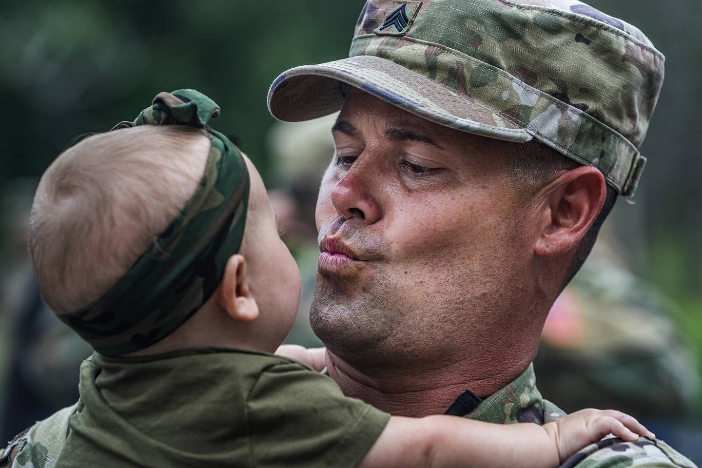 Sgt. Shawn Blakemore blows a kiss to his six-month old daughter Liv, Sunday, Aug. 9, 2020, as approximately 150 soldiers from the Stillwater-based 34th Military Police Company will deploy to Naval Station Guantanamo Bay in support of Joint Task Force Guantanamo to provide base security.