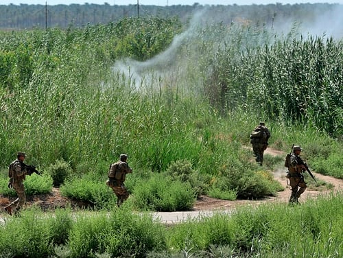 In this July 23, 2019, file photo, security forces detonate an explosive device placed by the Islamic State militants during a search operation in Taramiyah, 50 kilometers (31 miles) north of Baghdad, Iraq. (Hadi Mizban/AP)