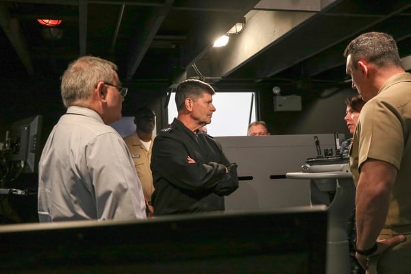 Vice Chief of Naval Operations Adm. Bill Moran listens as staff members from Surface Warfare Officers School explain the functions of the full bridge simulator. (Lt. Megan Chester/Navy)