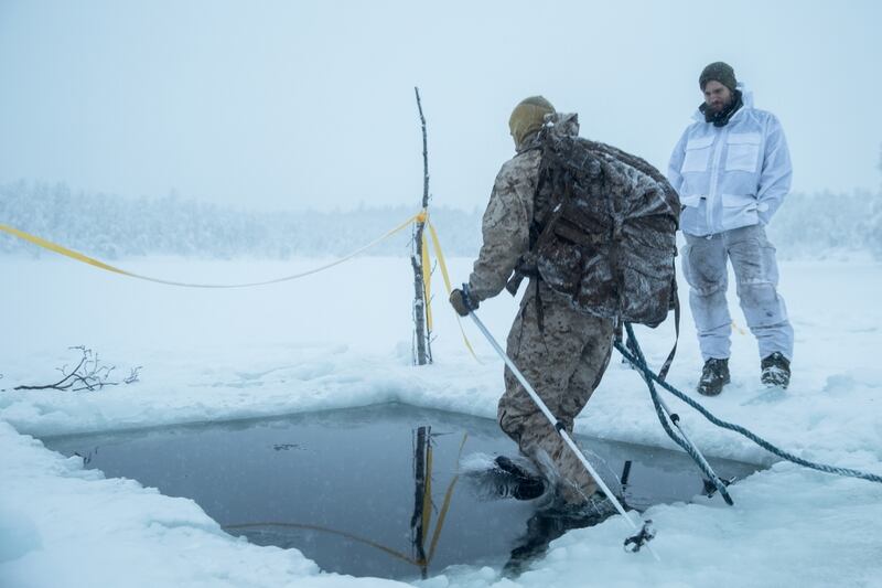 A U.S. Marine with Marine Rotational Force-Europe 19.1 jumps in freezing water during an ice-breaking drill as part of Exercise White Ulfberht in Setermoen, Norway, Jan. 22. (Cpl. Nghia Tran/Marine Corps)
