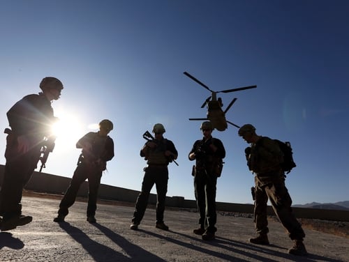U.S. troops wait on the tarmac in Logar province, Afghanistan, in November 2017. News reports allege that top officials in the White House were aware in early 2019 of classified intelligence indicating Russia was secretly offering bounties to the Taliban for the deaths of Americans. (Rahmat Gul/AP)