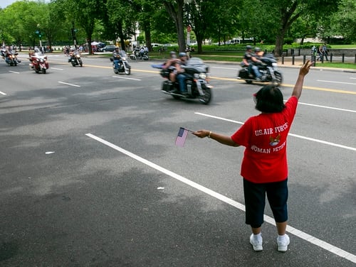 Air Force veteran Anna Sanders shows her support to riders during Rolling Thunder ride in Washington, D.C. on May 27, 2018. (Alan Lessig/Staff)