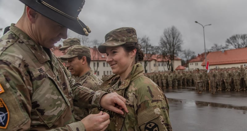 U.S. Army Sgt. Leann Roggensack, a cannon crewmember assigned to Battle Group Poland, is awarded an Army Commendation Medal, by U.S. Army Lt. Col. Donny Hebel, Commander of Battle Group Poland, for her outstanding military professionalism and performance, at Bemowo Piskie Training Area, Poland, Dec. 28, 2018. (Sgt. Sarah Kirby/Army)